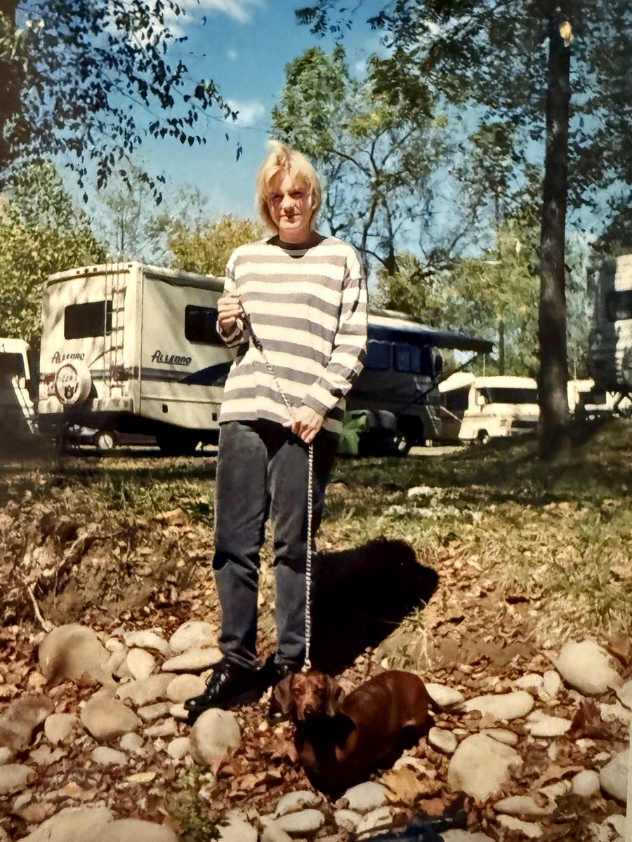 A person with a dachshund at a campground, from a digitized print